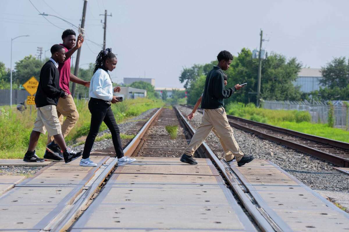 Students cross train tracks at dismissal at McReynolds Middle School in Houston, TX on August 20, 2025. Union Pacific has provided a design for a proposed pedestrian bridge at the school. The city has applied for a grant application through the Texas Department of Transportation to fund its construction.