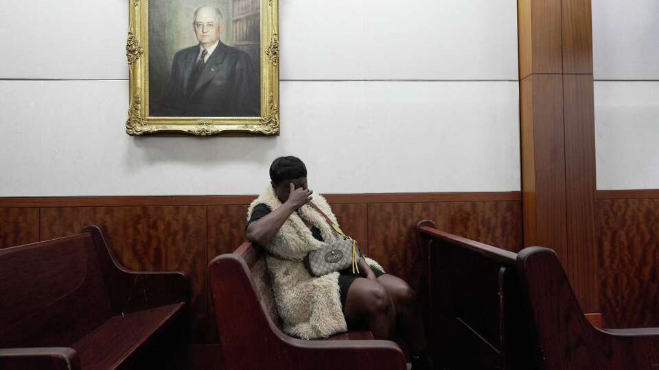 Pamela Busby waits for hours in court for a hearing over alleged fraud related to her son’s funeral on Thursday, Jan. 23, 2025 in Houston. The suspect never showed up.