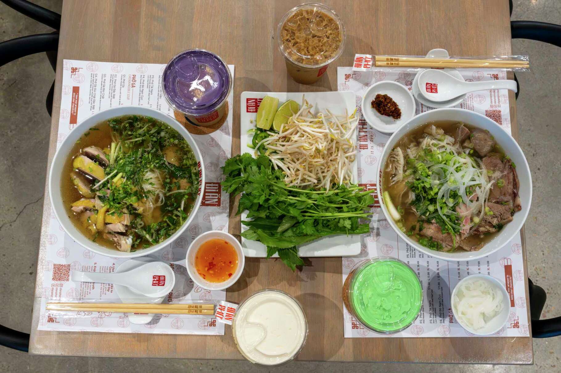 From left, chicken and beef pho are served with a variety of Vietnamese coffees at Di An Pho in Houston, Monday, Aug. 25, 2025.