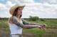 Torrie Martin at her fence line, near the area behind her fence line where a data center may be built, Aug. 26, 2025. Martin worries about the environmental impacts like water usage and sound pollution, as well as the safety of her animals.
