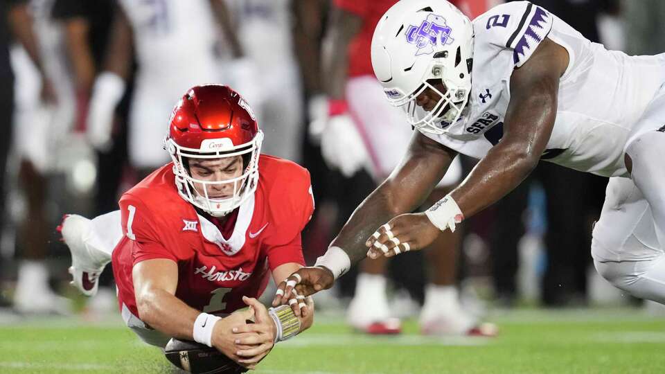 Houston Cougars quarterback Conner Weigman (1) recovers a fumble against Stephen F. Austin linebacker Aaron Austin (2) during the second half of a NCAA college football game at TDECU Stadium in Houston, Thursday, Aug. 28, 2025.
