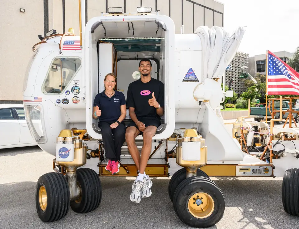 San Antonio Spurs' Victor Wembanyama sits on a lunar rover during a visit to NASA's Johnson Space Center in Houston on Aug. 29, 2025.