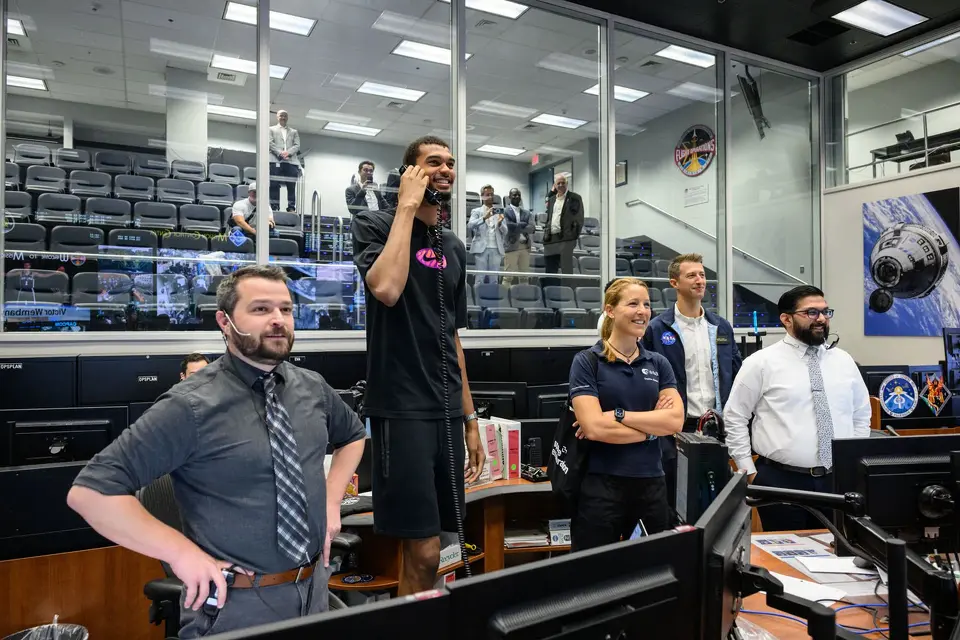 San Antonio Spurs' Victor Wembanyama talks on the phone to astronauts aboard the International Space Station during a visit to NASA's Johnson Space Center in Houston on Aug. 29, 2025.