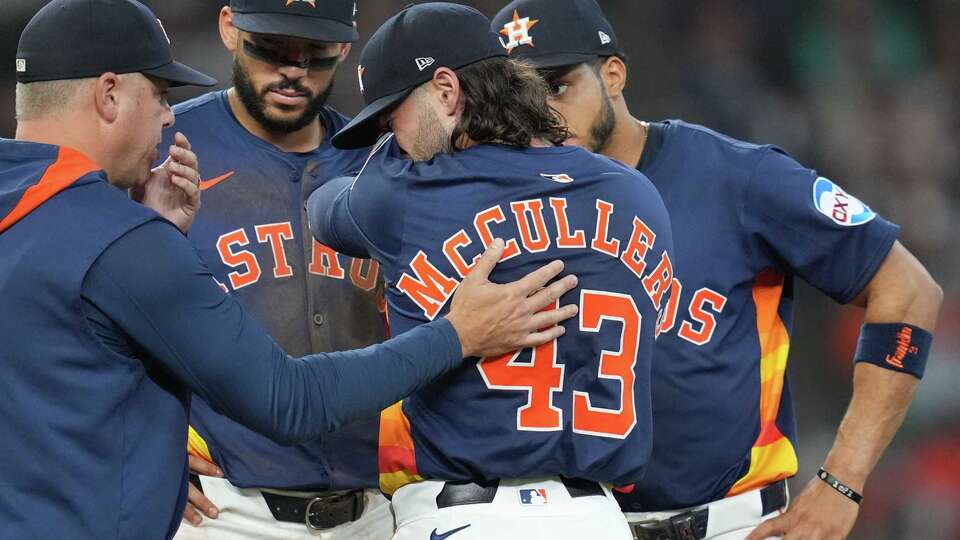 Meeting at the mounds after Houston Astros pitcher Lance McCullers Jr. (43) walked a player in the eighth inning against the Los Angeles Angels at Daikin Park in Houston on Sunday, Aug. 31, 2025.