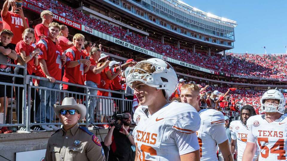 Texas Longhorns quarterback Arch Manning (16) walks past Ohio State fans flashing “Horns Down” as he heads to the locker room after losing 14-7 to the Buckeyes at Ohio Stadium in Columbus, Aug. 30, 2025.