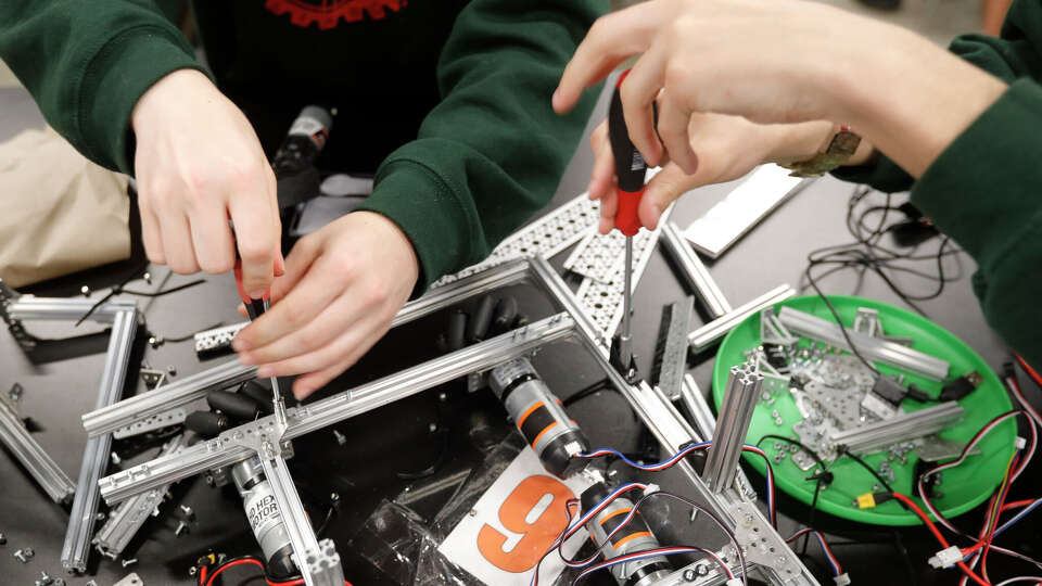 Maren Eaton and Lawrence Granda build a robot at The Woodlands High School, Wednesday, April 21, 2022, in The Woodlands. The school's robotics team, the Rigatoni Pastabots, won first in the Tech Challenge Group II during the UIL Robotics State Championships in Houston.