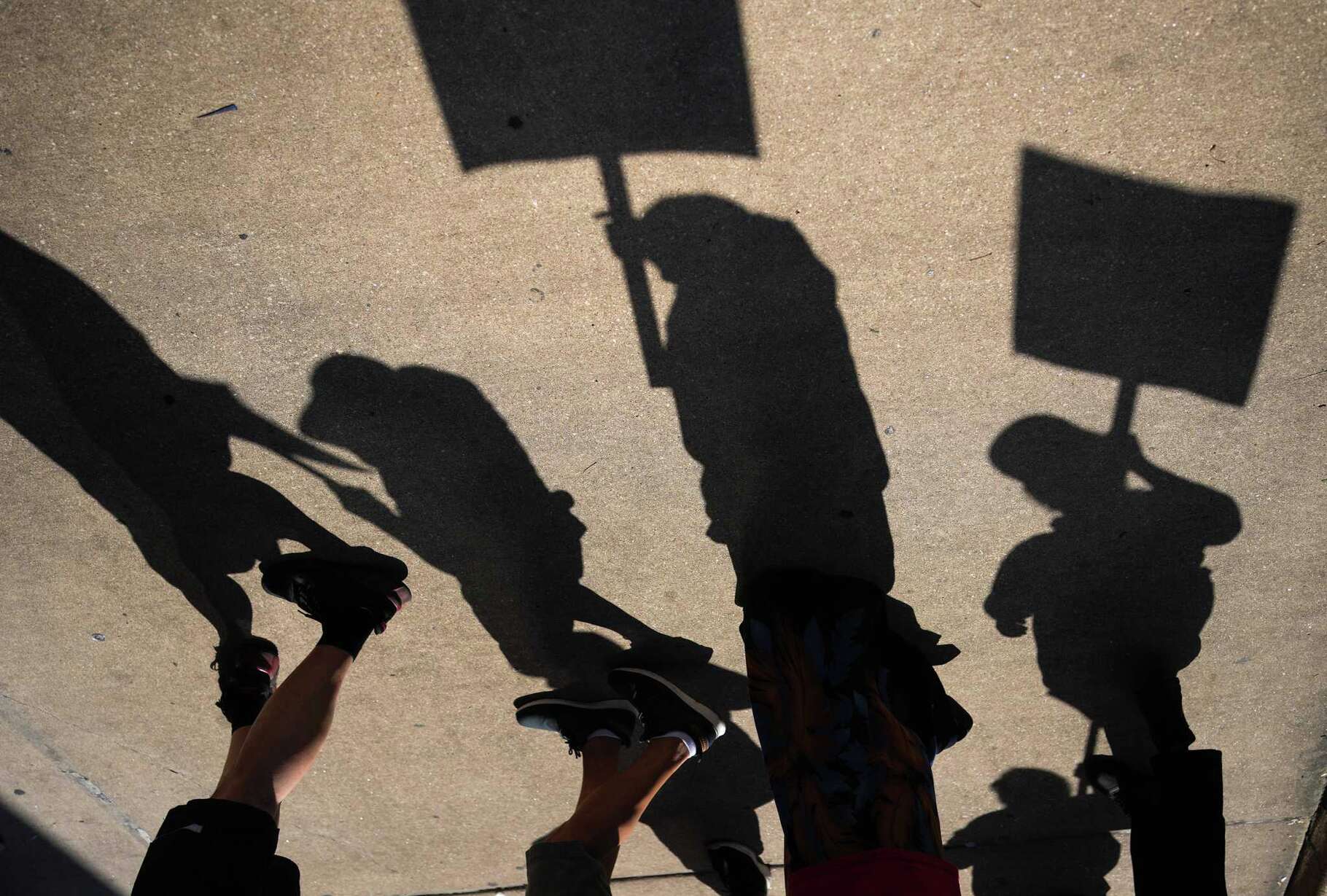 Unionized hotel workers march on a picket line for day 3 of a 10-day strike in front of Hilton Americas in Houston on Wednesday, Sept. 3, 2025.