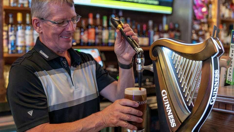 Owner Kevin McElroy pulls a perfect Guinness pint behind the bar at Pimlico Irish Pub in Houston, Thursday, Sept. 4, 2025.