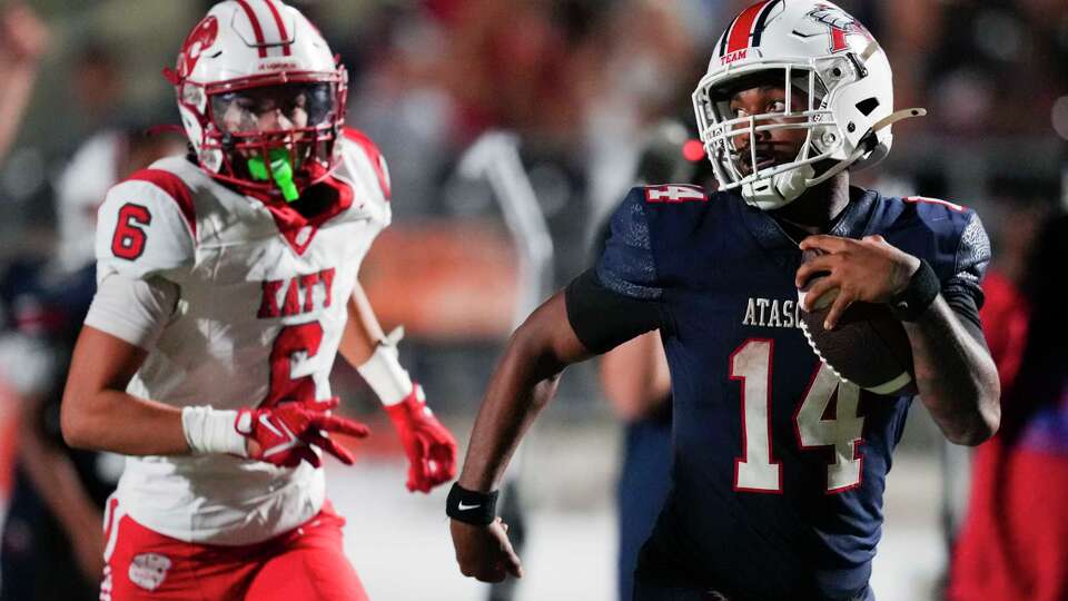 Atascocita quarterback Cardae Mack runs past Katy’s Riley Revere during the second half of a high school football game in Humble, Friday, Sept. 5, 2025.