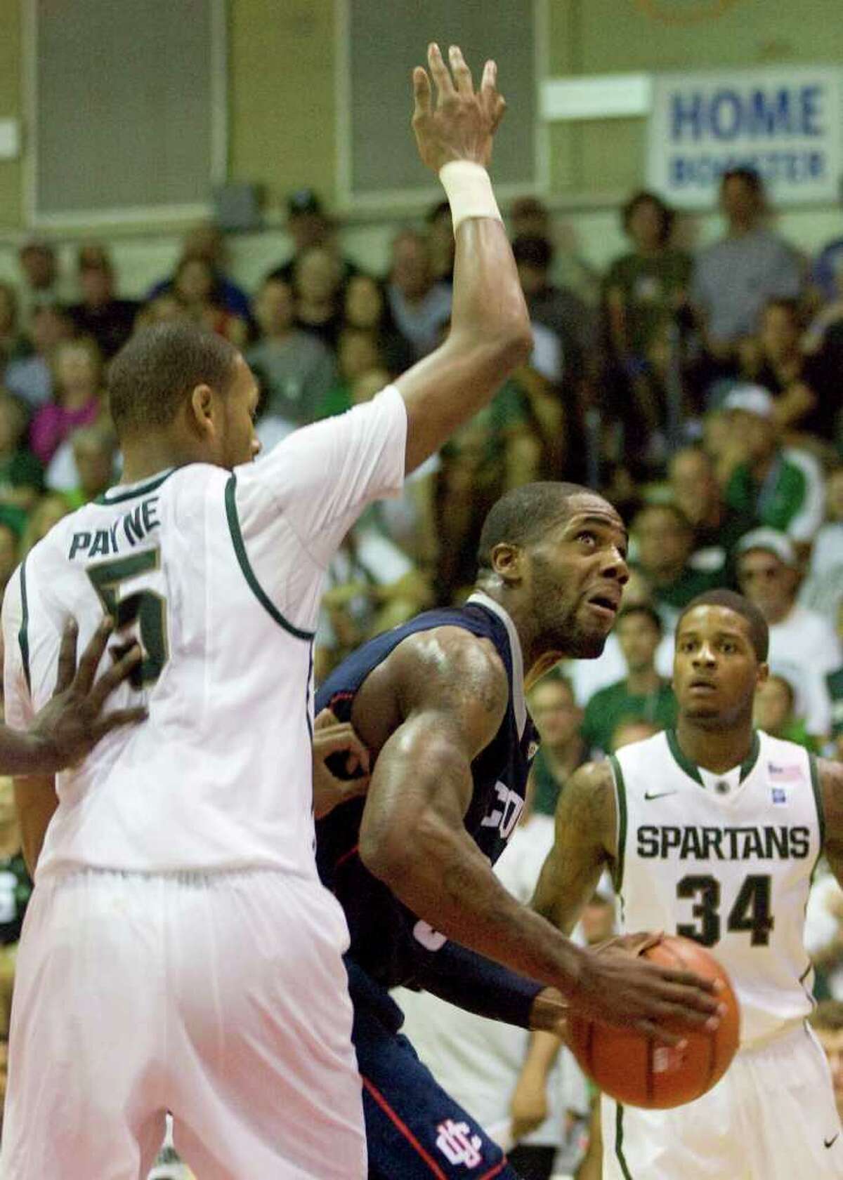 Michigan State center Adreian Payne (5) guards Connecticut's Alex Oriakhi in the first half of a NCAA college basketball game at the Maui Invitational in Lahaina, Hawaii Tuesday, Nov. 23, 2010. (AP Photo/Eugene Tanner)