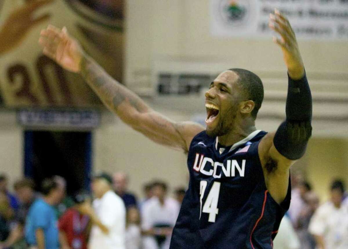 Connecticut's Alex Oriakhi celebrates after his team defeated Michigan State 70-67 in a Maui Invitational NCAA college basketball game, in Lahaina, Hawaii Tuesday, Nov. 23, 2010. (AP Photo/Eugene Tanner)