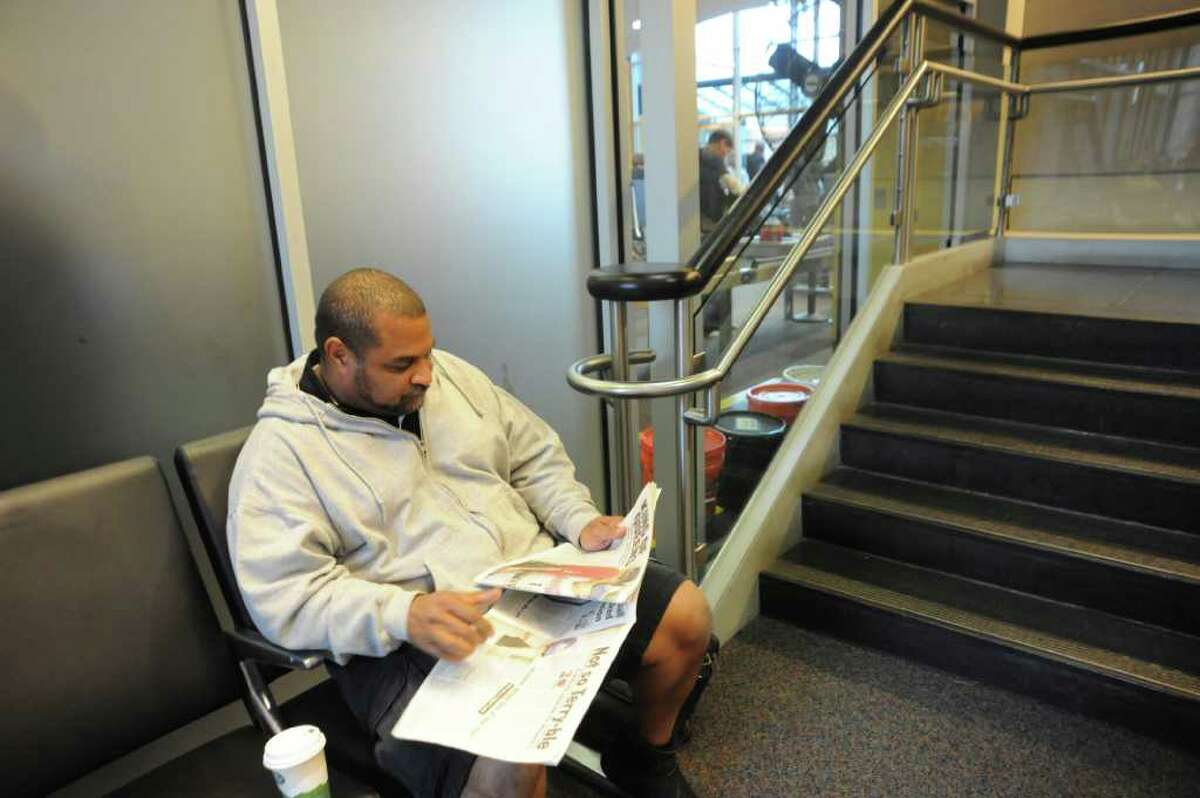 Tomas Ortiz reads a news paper, waiting for his JetBlue plane to go to Orlando, Fla., at Westchester County Airport, in White Plains, N.Y. on Tuesday, Nov. 23, 2010.