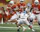Texas Longhorns quarterback Arch Manning (16) evades a tackle by San José State linebacker Taniela Latu (4) during the game at Darrell K Royal–Texas Memorial Stadium on Saturday, Sept. 6, 2025.