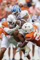 Texas Longhorns linebacker Trey Moore (8) and Texas Longhorns defensive back Santana Wilson (28) take down San Jose State Spartans running back Floyd Chalk IV (3) during the game against San Jose State at Darrell K Royal–Texas Memorial Stadium in Austin, Saturday, Sept. 6, 2025.