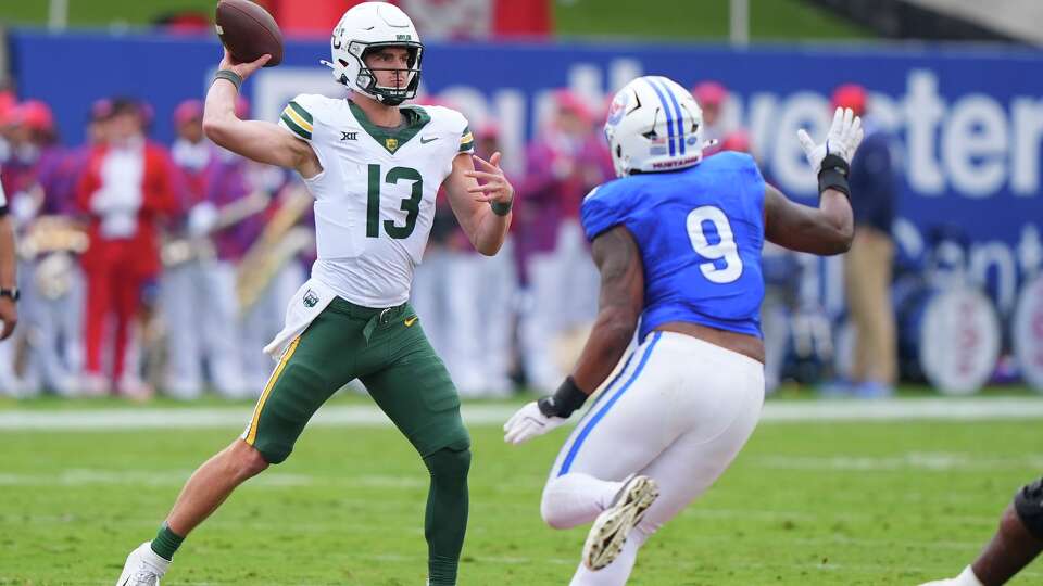 Baylor quarterback Sawyer Robertson (13) passes as SMU defensive end Cameron Robertson (9) rushes in during the first half of an NCAA college football game Saturday, Sept. 6, 2025, in Dallas.