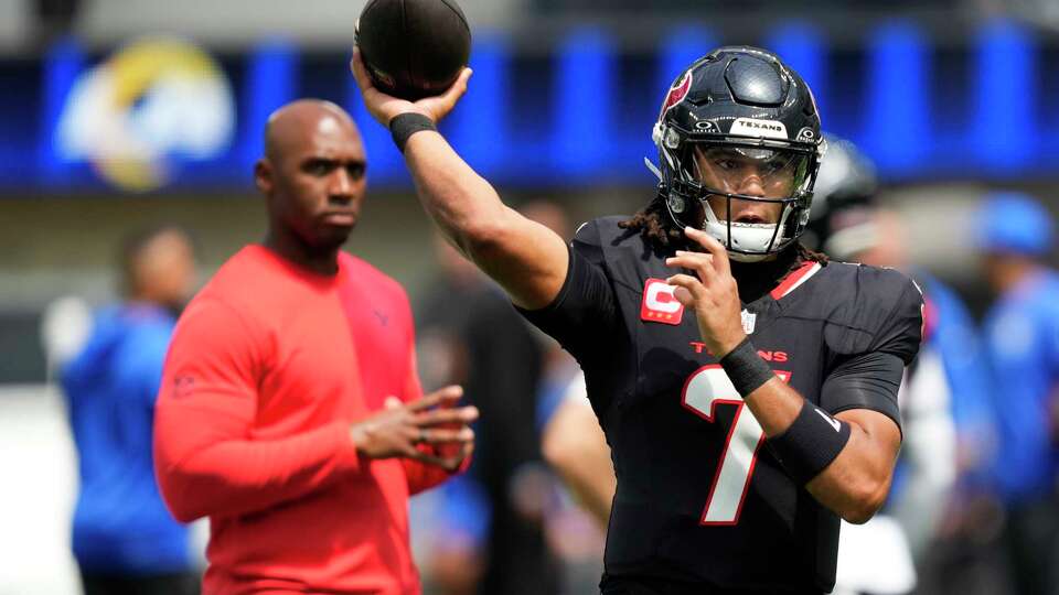 Houston Texans quarterback C.J. Stroud (7) warms up in front of head coach DeMeco Ryans before an NFL football game at SoFi Stadium in Inglewood, Calif., Sunday, Sept. 7, 2025.