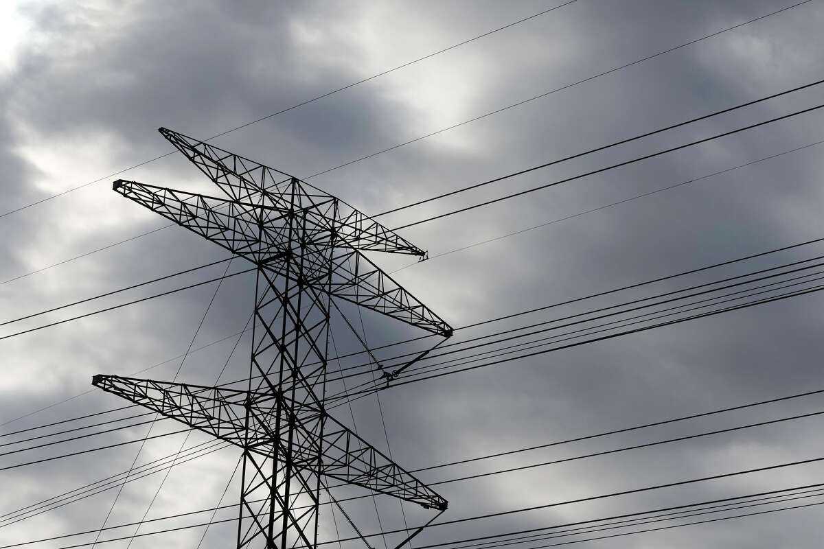 Transmission power lines are shown along Sam Houston Tollway at Hollister St. Wednesday, Oct. 16, 2024, in Houston.