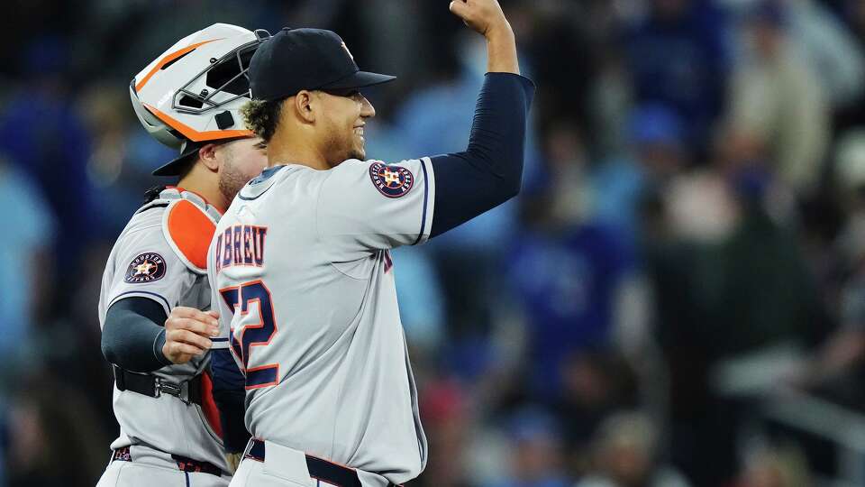 Houston Astros pitcher Bryan Abreu, right, celebrates after defeating the Toronto Blue Jays with catcher Yainer Diaz in a baseball game in Toronto on Wednesday, Sept. 10, 2025. (Nathan Denette/The Canadian Press via AP)