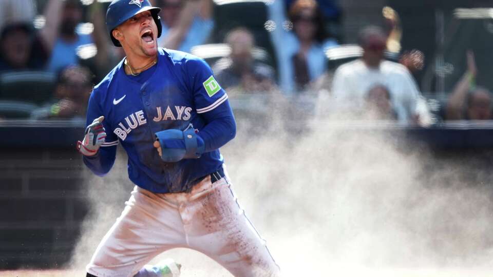 Toronto Blue Jays' George Springer reacts after scoring a run against the Houston Astros during the first inning of a baseball game in Toronto, Thursday, Sept. 11, 2025. (Nathan Denette/The Canadian Press via AP)