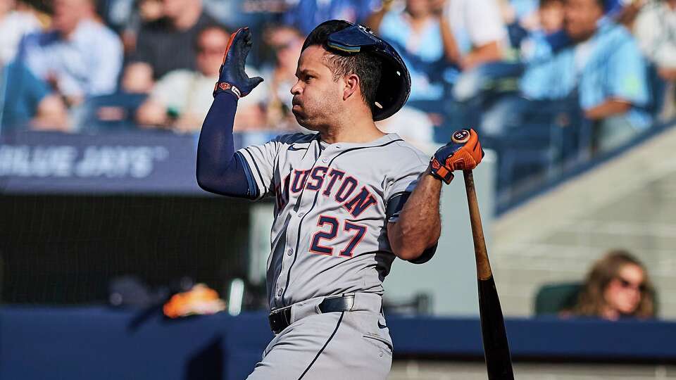 Houston Astros' Jose Altuve (27) strikes out against the Toronto Blue Jays during the seventh inning of a baseball game in Toronto, Thursday, Sept. 11, 2025. (Sammy Kogan/The Canadian Press via AP)