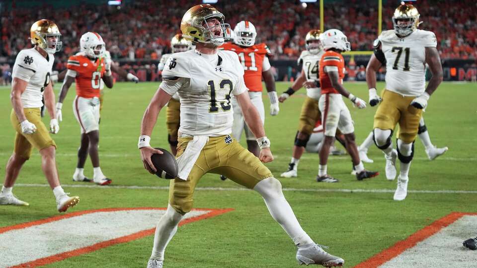 Notre Dame quarterback CJ Carr (13) celebrates after scoring a touchdown during the second half of an NCAA college football game against Miami, Sunday, Aug. 31, 2025, in Miami Gardens, Fla. (AP Photo/Lynne Sladky)