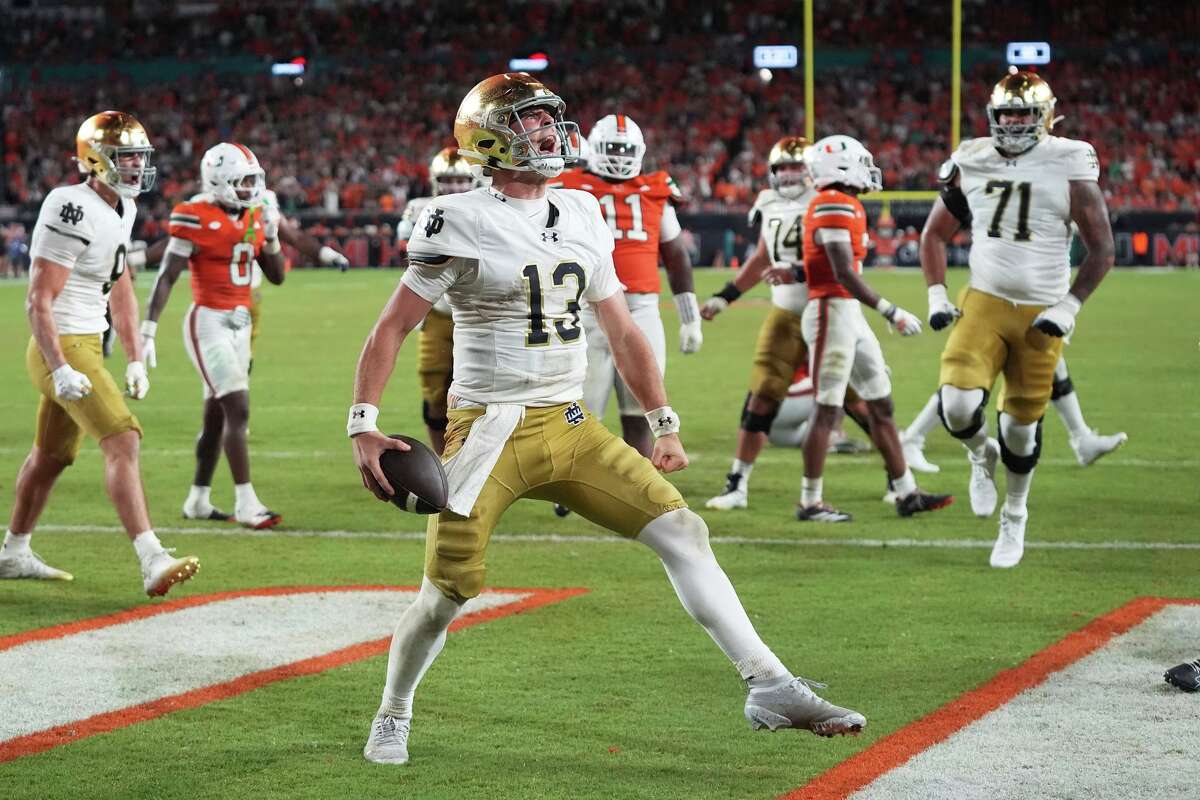 Notre Dame quarterback CJ Carr (13) celebrates after scoring a touchdown during the second half of an NCAA college football game against Miami, Sunday, Aug. 31, 2025, in Miami Gardens, Fla. (AP Photo/Lynne Sladky)