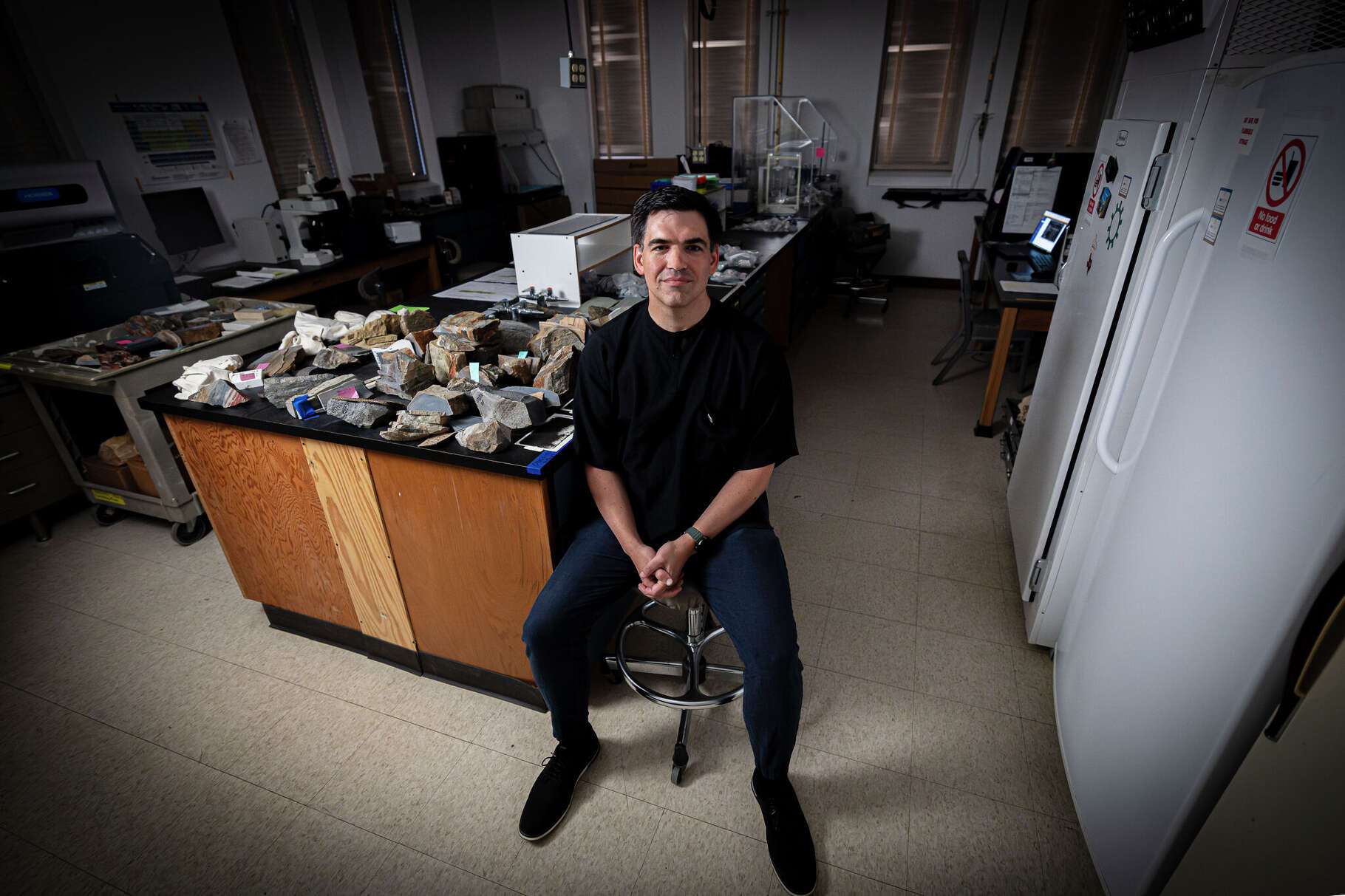Mike Tice, a research scientist in geobiology and sedimentary geology from Texas A&M University, poses among a large collection of rocks in his lab on Wednesday, Aug. 20, 2025, in College Station, Texas. (Abbey Toronjo/Texas A&M University Division of Marketing & Communications)