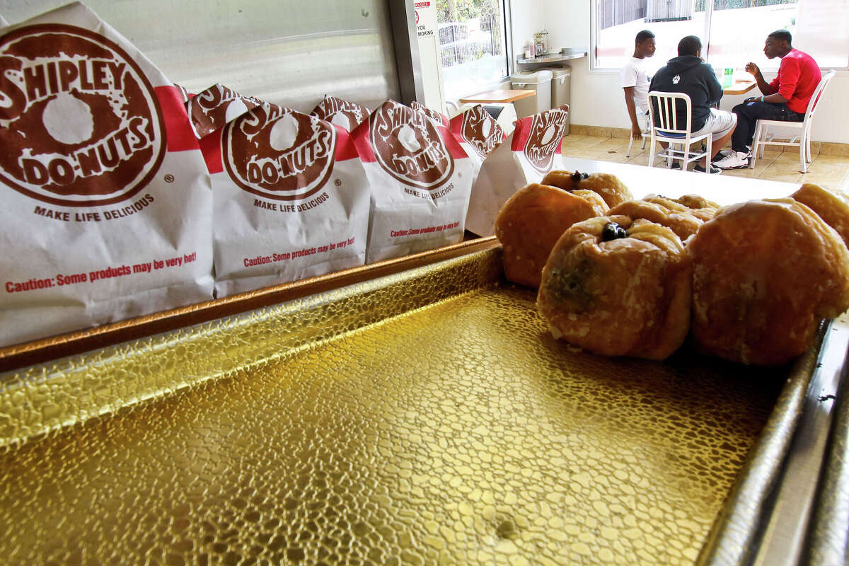 Jalen Riggs, right (red) and his friends enjoy Shipley's Do-nuts in the Dairy Ashford modern designed store Wednesday, Dec. 19, 2012, in Houston. ( Nick de la Torre / Houston Chronicle ) (Photo by Nick de la Torre/Houston Chronicle via Getty Images)