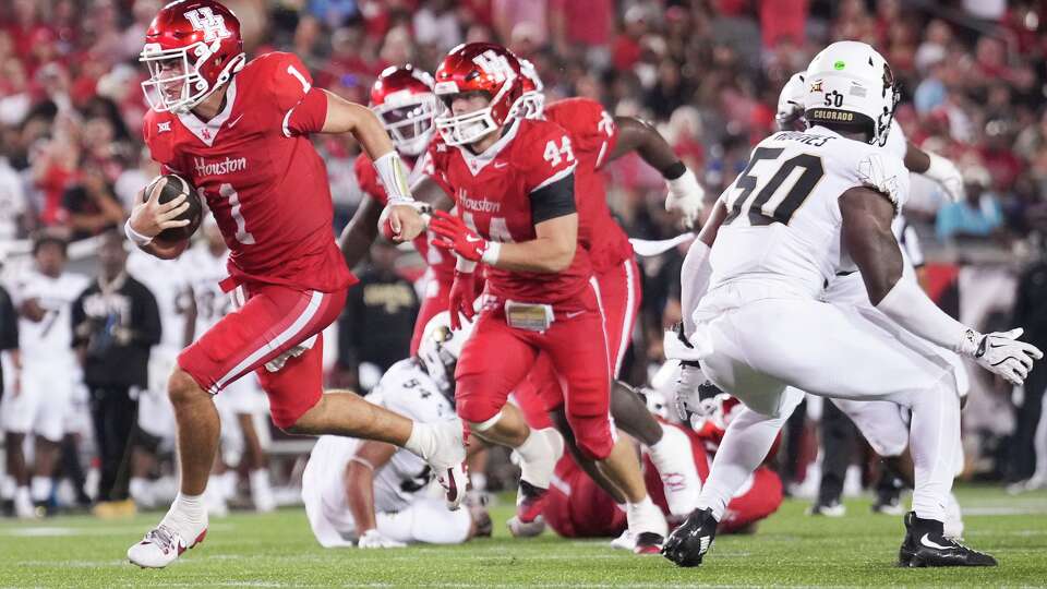 Houston quarterback Conner Weigman (1) runs for a 7-yard touchdown during the second half of a Big 12 Conference college football game in Houston, Friday, Sept. 12, 2025.
