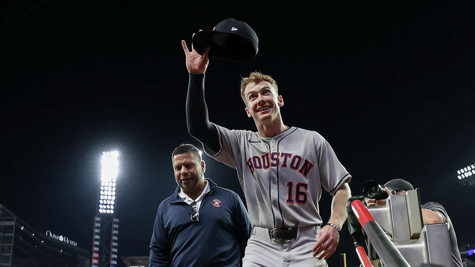 Houston Astros' Zach Cole (16) salutes the crowd after a baseball game against the Atlanta Braves, Friday, Sept. 12, 2025, in Atlanta. (AP Photo/Colin Hubbard)