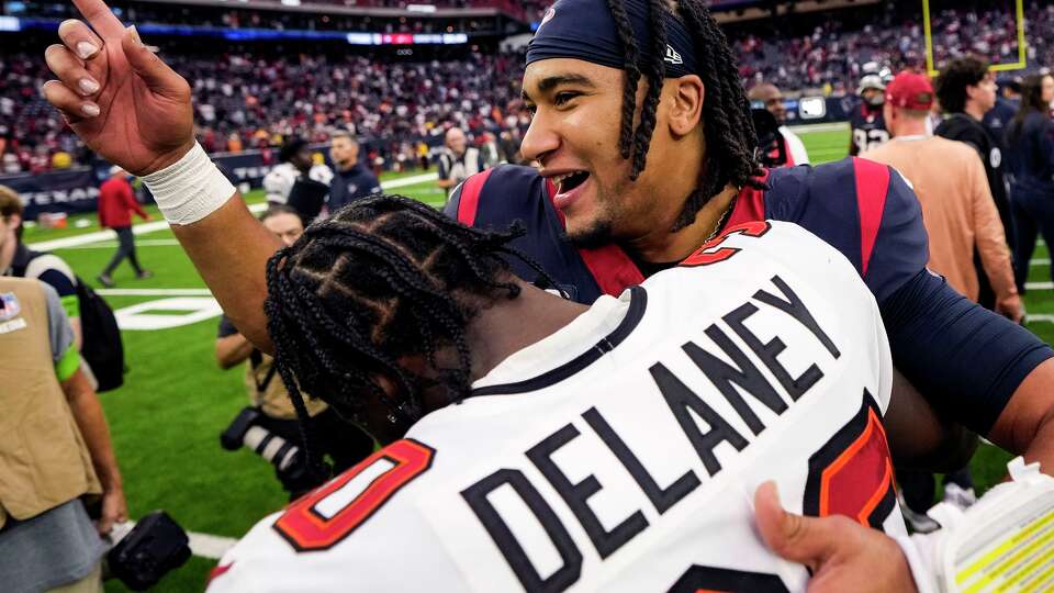 Houston Texans quarterback C.J. Stroud (7) hugs Tampa Bay Buccaneers cornerback Dee Delaney (30) after the Texans 39-37 win in an NFL football game Sunday, Nov. 5, 2023, in Houston.