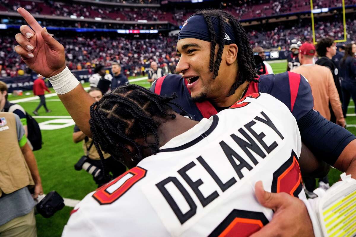 Houston Texans quarterback C.J. Stroud (7) hugs Tampa Bay Buccaneers cornerback Dee Delaney (30) after the Texans 39-37 win in an NFL football game Sunday, Nov. 5, 2023, in Houston.