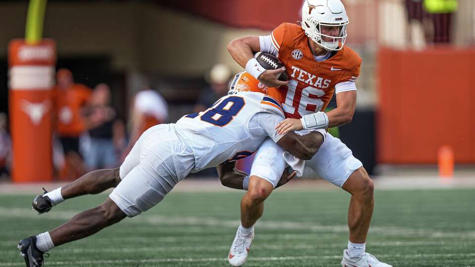 Texas Longhorns quarterback Arch Manning (16) is hit by UTEP linebacker Micah Davey (48) during the game at Darrell K Royal–Texas Memorial Stadium on Saturday, Sep. 13, 2025.