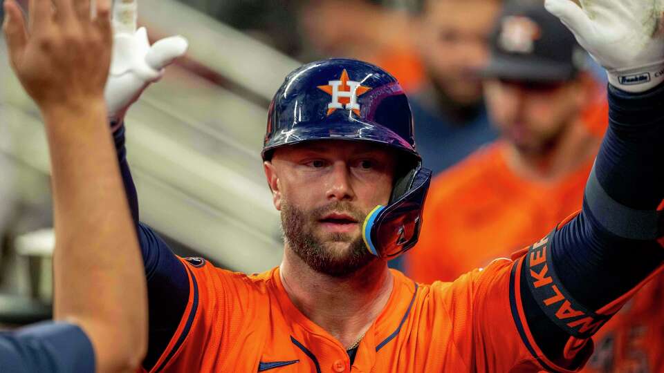 Houston Astros' Christian Walker (8) celebrates after scoring a run during the third inning of a baseball game against the Atlanta Braves, Saturday, Sept. 13, 2025, in Atlanta. (AP Photo/Erik Rank)