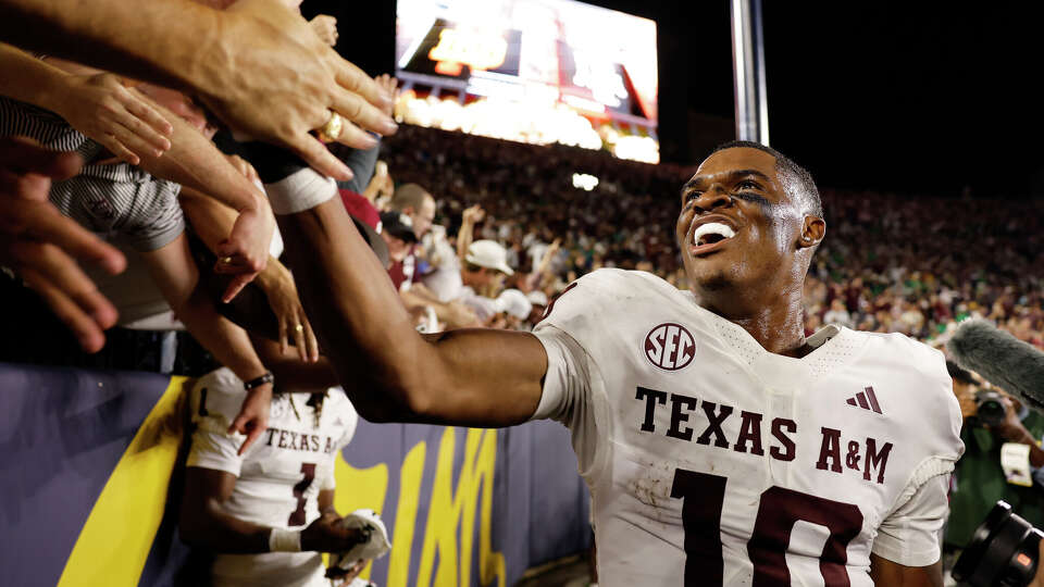 SOUTH BEND, INDIANA - SEPTEMBER 13: Marcel Reed #10 of the Texas A&M Aggies high fives fans after defeating the Notre Dame Fighting Irish at Notre Dame Stadium on September 13, 2025 in South Bend, Ind. (Photo by Michael Reaves/Getty Images)