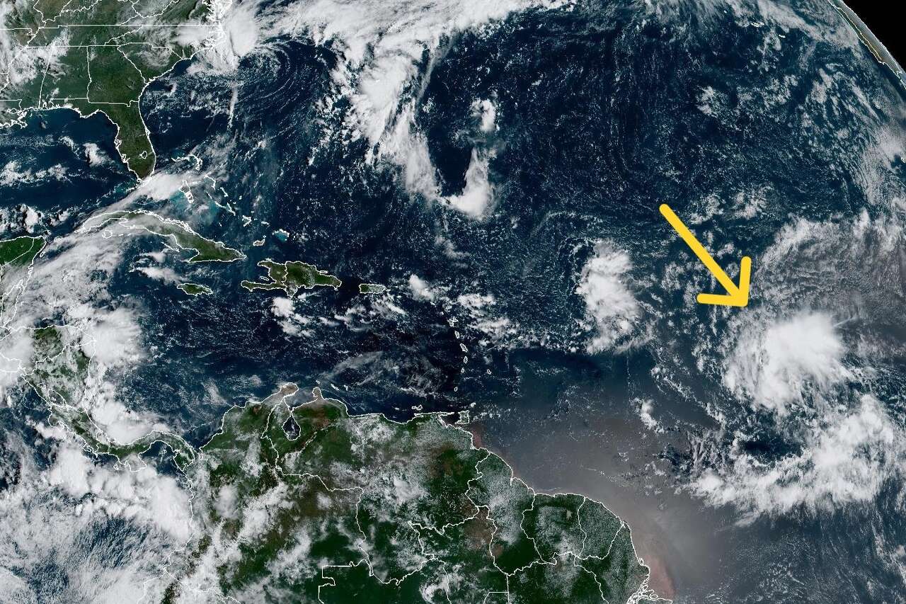 In this weather satellite photo of the tropical Atlantic Ocean taken at 8:30 a.m. Monday, we've superimposed a yellow arrow to indicate a tropical wave of low pressure that has an 80% chance of becoming a tropical cyclone in the next seven days.