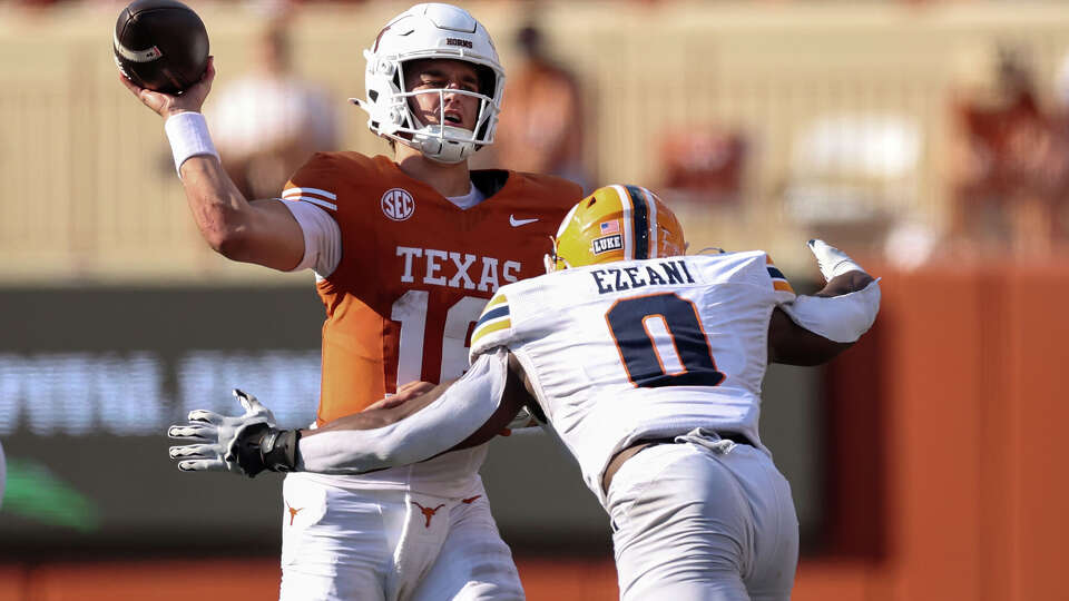AUSTIN, TEXAS - SEPTEMBER 13: Arch Manning #16 of the Texas Longhorns throws a pass under pressure by Udoka Ezeani #0 of the UTEP Miners in the second half at Darrell K Royal-Texas Memorial Stadium on September 13, 2025 in Austin, Texas. (Photo by Tim Warner/Getty Images)