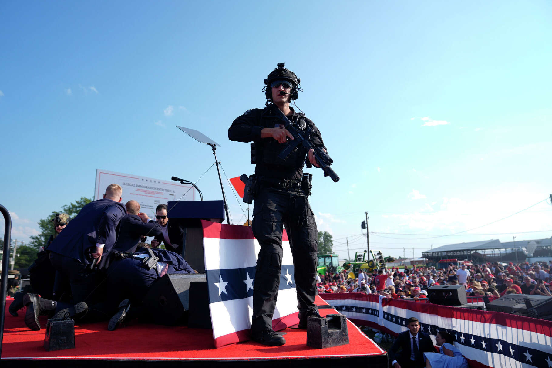 Republican presidential candidate former President Donald Trump is surrounded by U.S. Secret Service agents on stage at a campaign rally, Saturday, July 13, 2024, in Butler, Pa. (AP Photo/Evan Vucci)