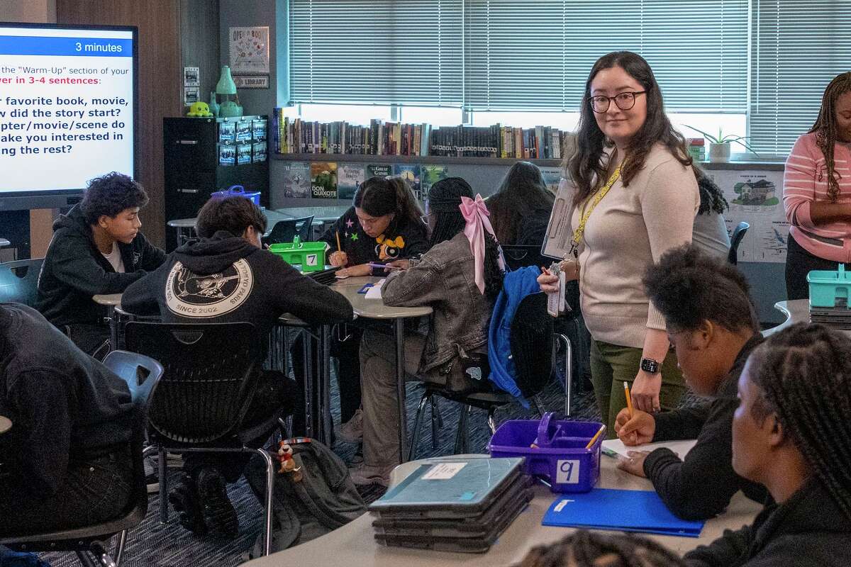 English teacher Jessica Gallo assists students during a writing exercise in her classroom at Dekaney High School in Houston, Tuesday, Sept. 16, 2025.