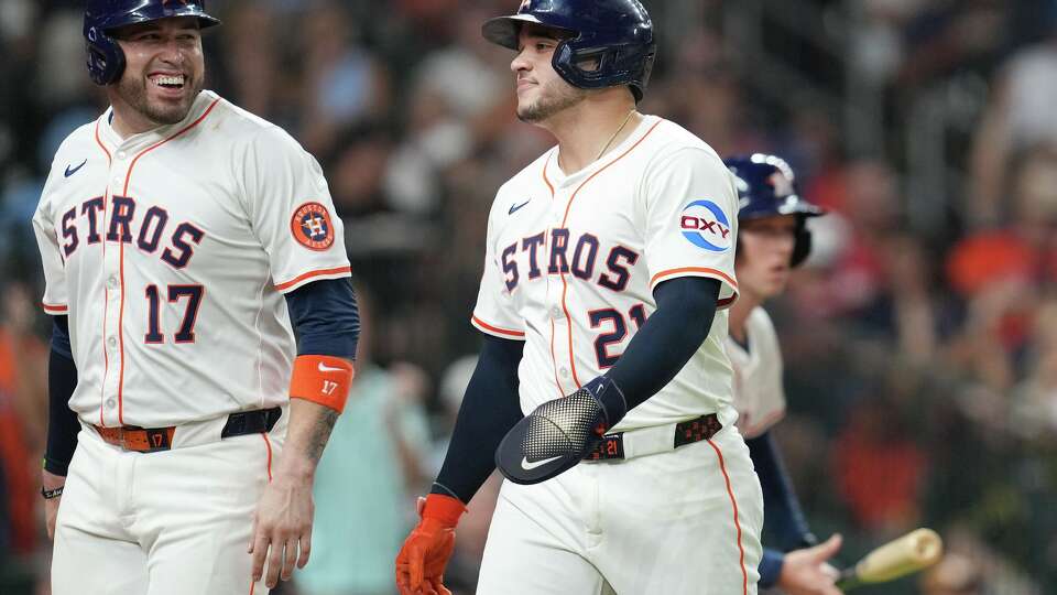 Houston Astros Victor Caratini (17) and Yainer Diaz (21) congratulate each other after scoring off of a single by Jesús Sánchez (4) against the Texas Rangers at Daikin Park in Houston on Tuesday, Sept. 16, 2025.