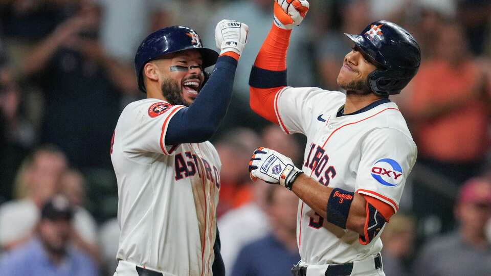 Houston Astros Jeremy Peña, right, celebrates with Carlos Correa after hitting a solo home run off Texas Rangers pitcher Jacob deGrom during the fifth inning of a MLB baseball game in Houston, Wednesday, Sept. 17, 2025.