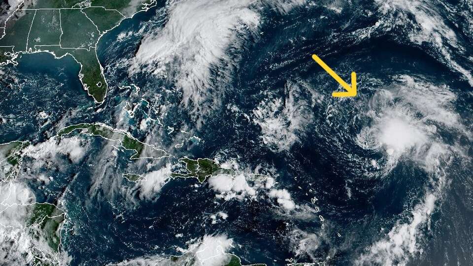 Gabrielle, marked in this weather satellite photo by a yellow arrow, was expected to strengthen from a tropical storm into a hurricane by Sunday, according to the National Hurricane Center.