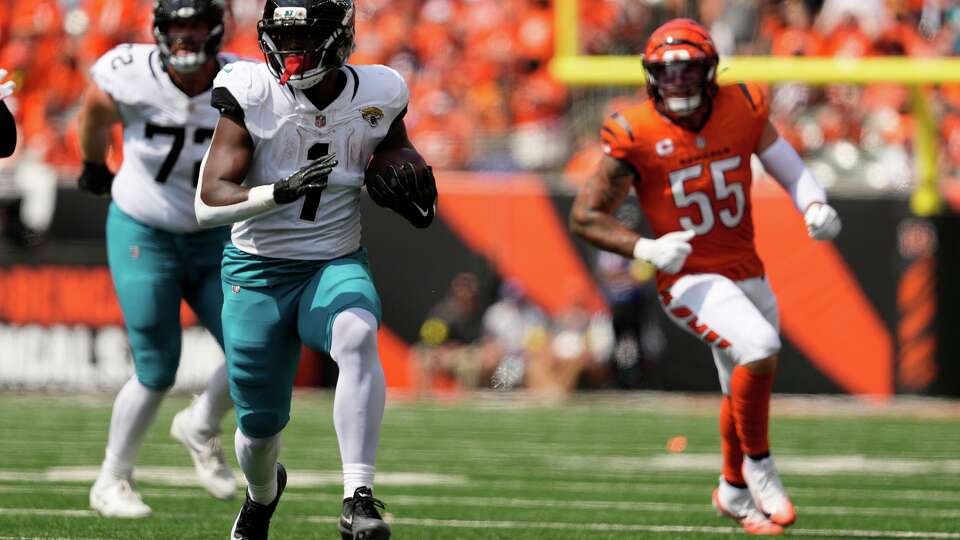 Jacksonville Jaguars running back Travis Etienne Jr. (1) carries during the first half of an NFL football game against the Cincinnati Bengals, Sunday, Sept. 14, 2025, in Cincinnati. (AP Photo/Carolyn Kaster)