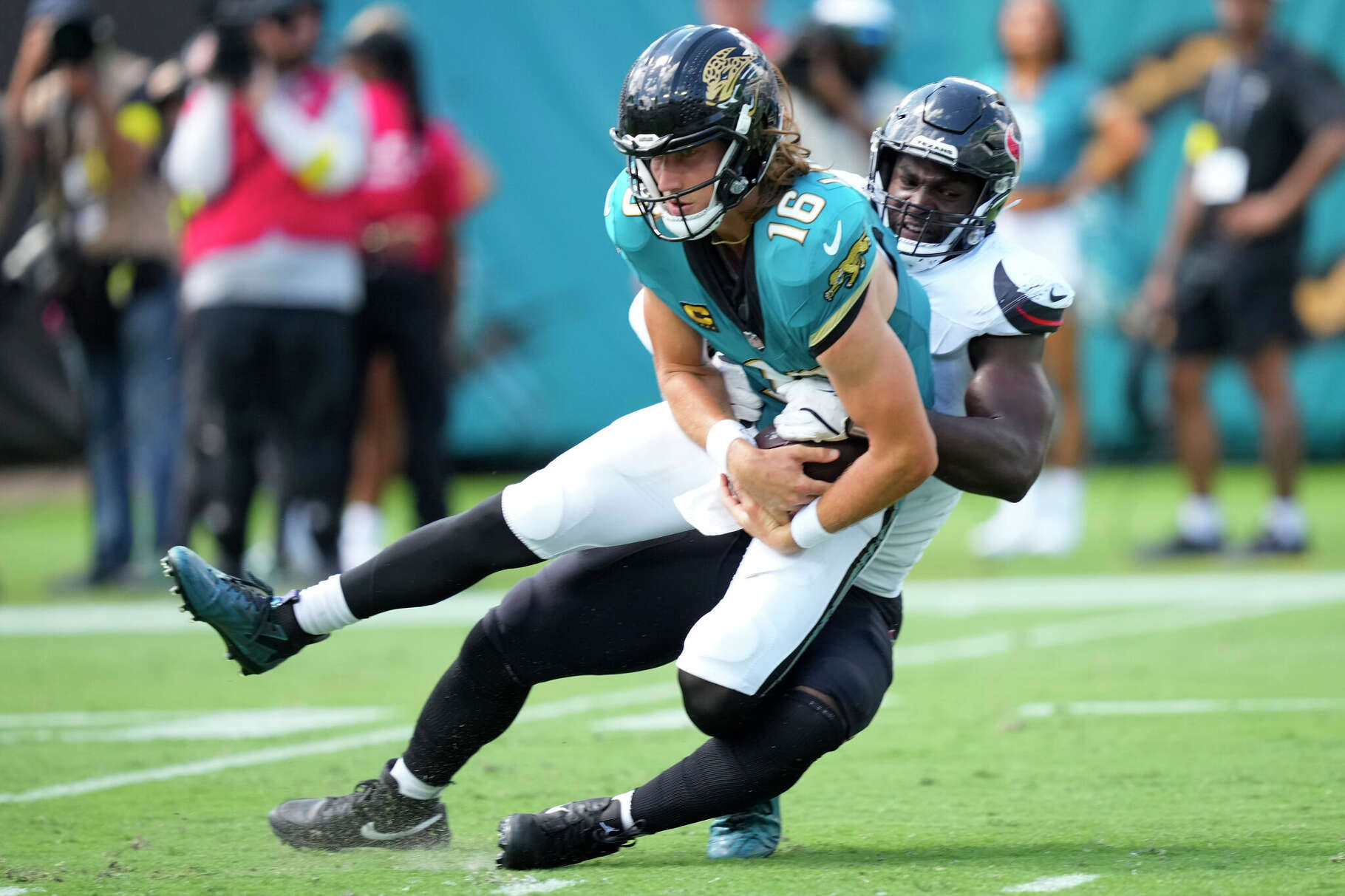 Houston Texans defensive end Will Anderson Jr. (51) sacks Jacksonville Jaguars quarterback Trevor Lawrence (16) during the first half of an NFL football game at Everbank Stadium in Jacksonville, Fla., Sunday, Sept. 21, 2025.