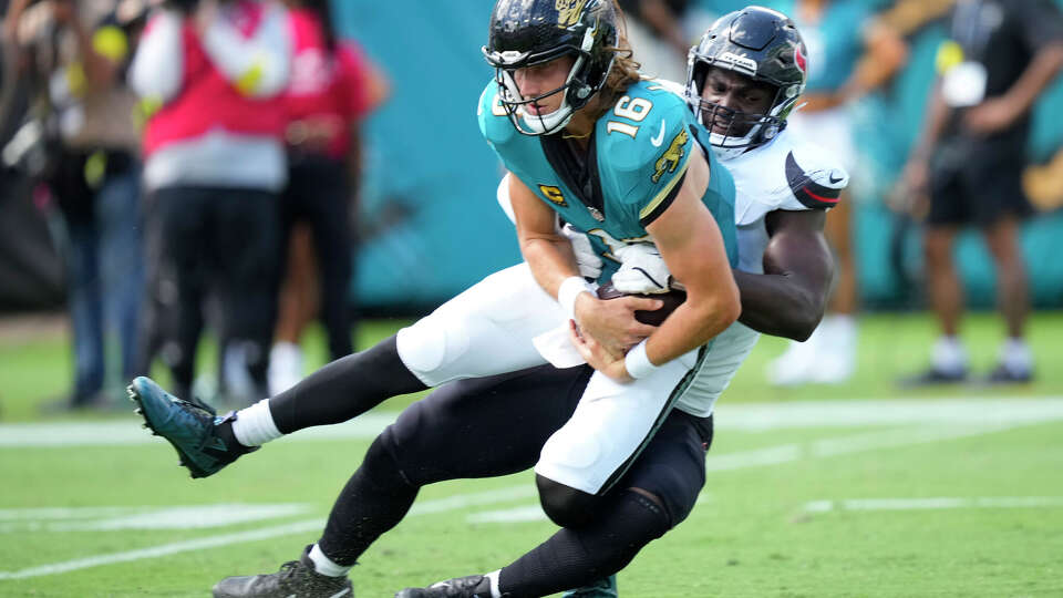 Houston Texans defensive end Will Anderson Jr. (51) sacks Jacksonville Jaguars quarterback Trevor Lawrence (16) during the first half of an NFL football game at Everbank Stadium in Jacksonville, Fla., Sunday, Sept. 21, 2025.