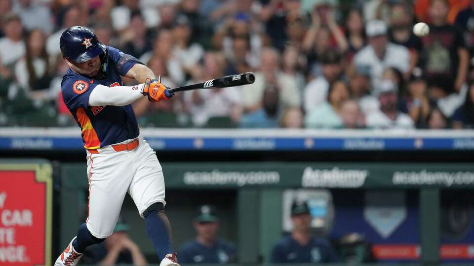 Houston Astros Jose Altuve (27) hits an RBI single during the seventh inning of a MLB baseball game in Houston, Sunday, Sept. 21, 2025.