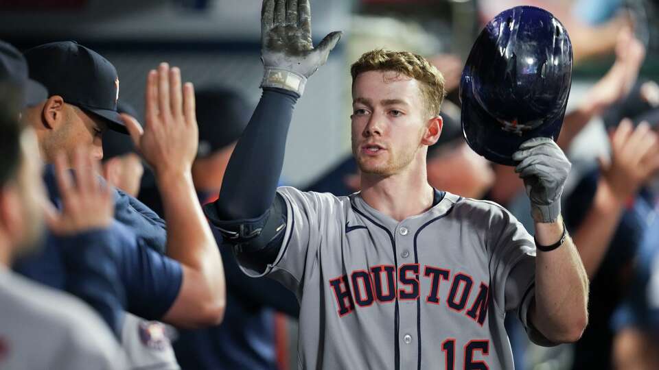 Houston Astros Zach Cole (16) gets high-fives in the dugout after hitting a 2-run home run off Los Angeles Angels starting pitcher Caden Dana during the second inning a MLB baseball game in Anaheim, Saturday, Sept. 27, 2025.