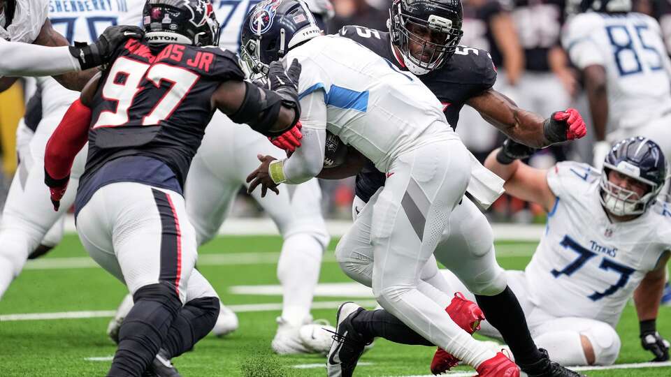 Houston Texans defensive end Danielle Hunter (55) sacks Tennessee Titans quarterback Cam Ward (1) during the first half of an NFL football game at NRG Stadium in Houston, Sunday, Sept. 28, 2025.