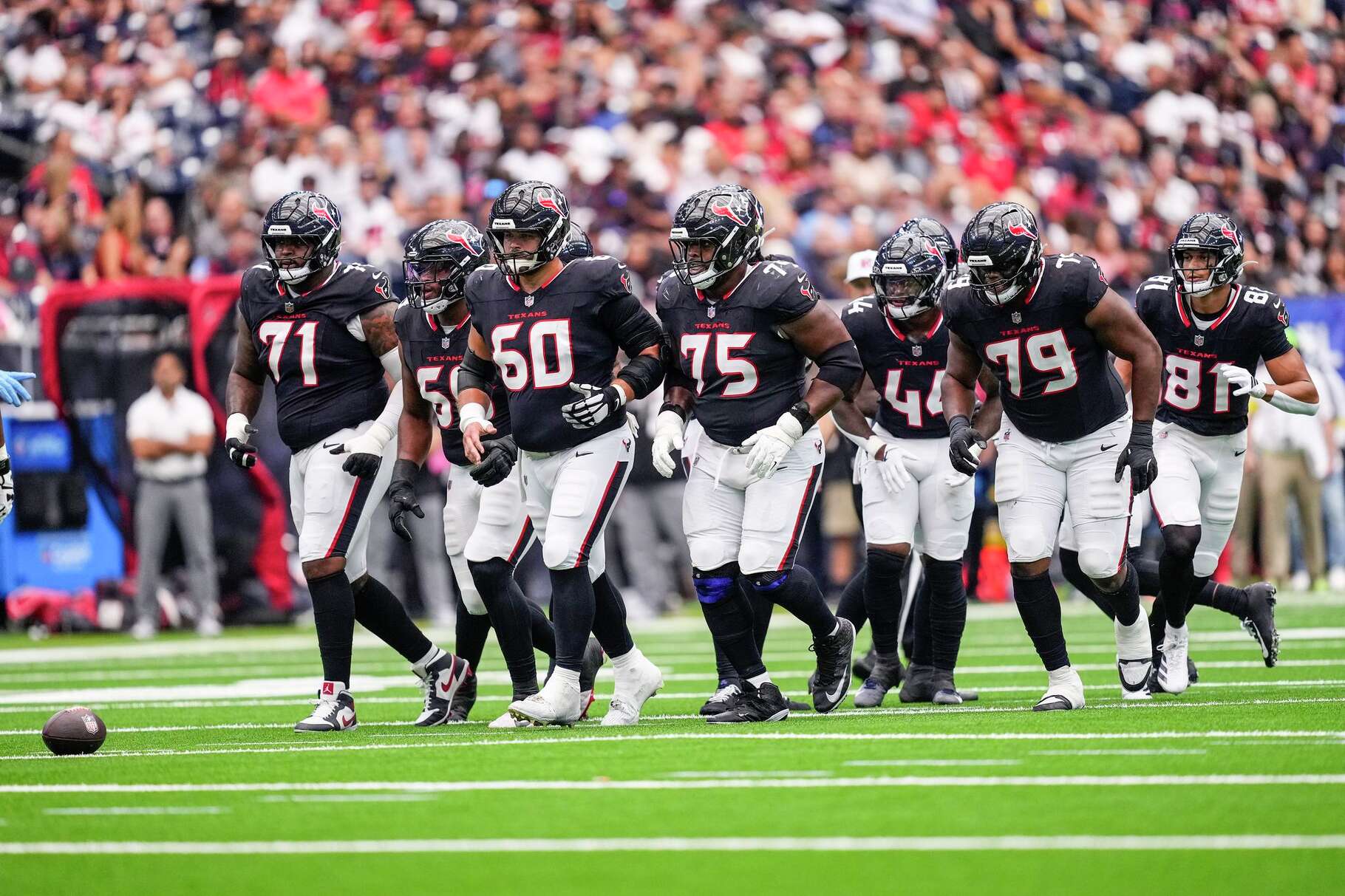 The Houston Texans offensive line breaks out of the huddle to line up for a play against the Tennessee Titans during the first half of an NFL football game at NRG Stadium in Houston, Sunday, Sept. 28, 2025.