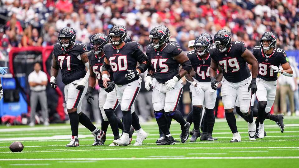 The Houston Texans offensive line breaks out of the huddle to line up for a play against the Tennessee Titans during the first half of an NFL football game at NRG Stadium in Houston, Sunday, Sept. 28, 2025.